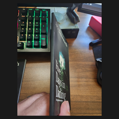 Book titled 'Five Days in Dating' held by the author JE Teitsworth showing text missing from the spine of the book.