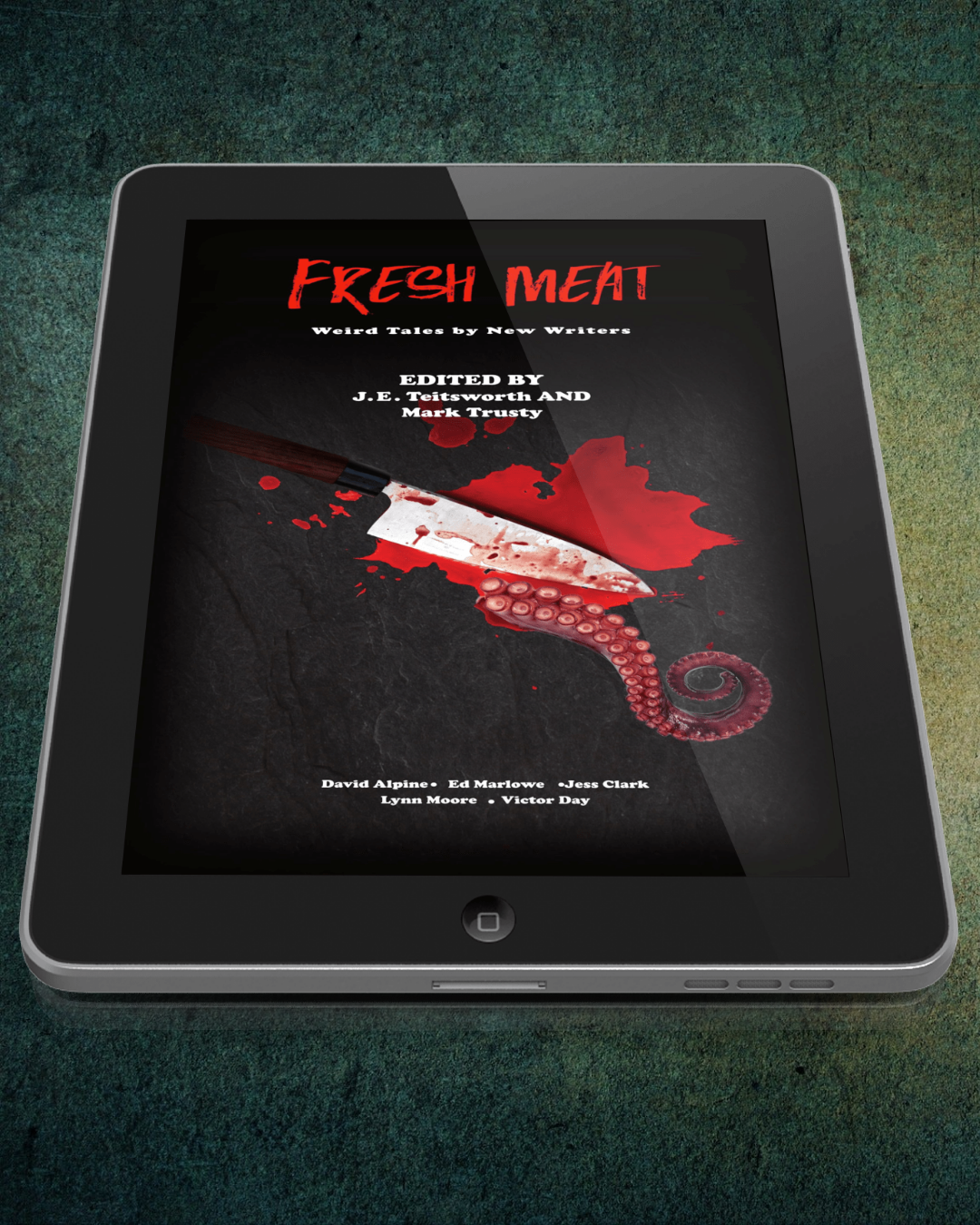 A tablet device displaying a book cover titled "Fresh Meat" with a dark horror-themed design featuring red text, blood splatter, and a knife with a tentacle wrapped around the blade. The tablet is placed on a textured dark green surface.
