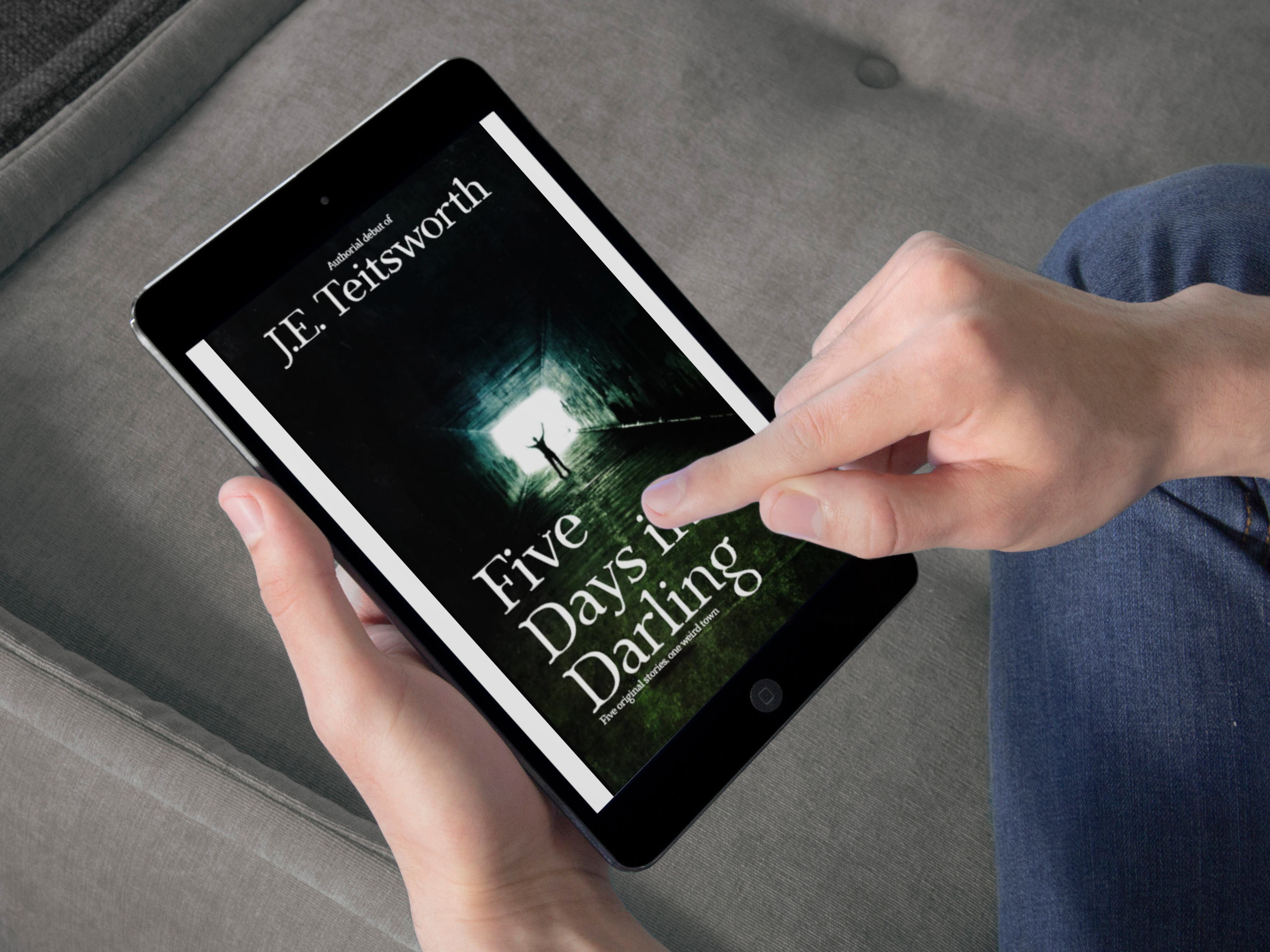 Person holding a tablet with the book cover for Five Days in Darling displayed on the screen